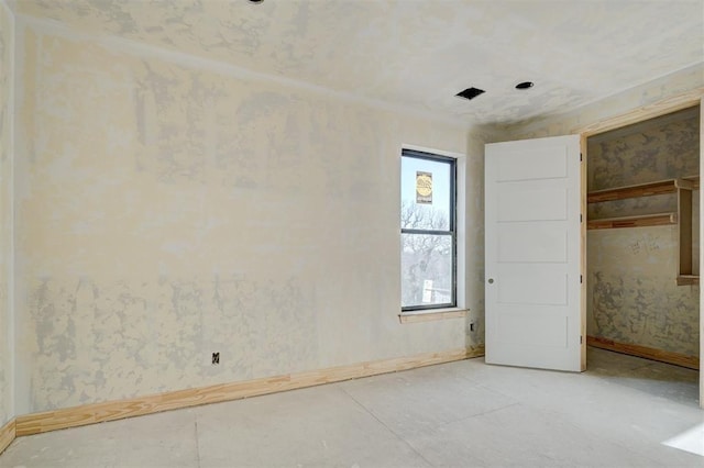 spare room featuring baseboards