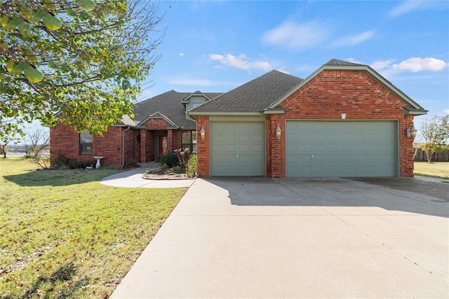 view of front of home featuring a front yard and a garage