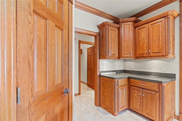 kitchen featuring crown molding and light tile patterned floors