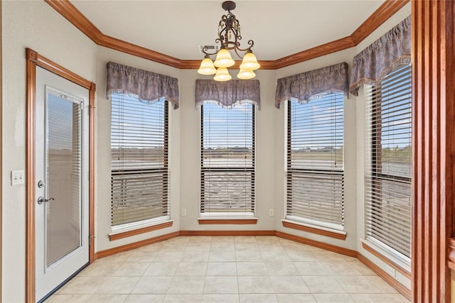 unfurnished dining area with a healthy amount of sunlight, crown molding, and an inviting chandelier