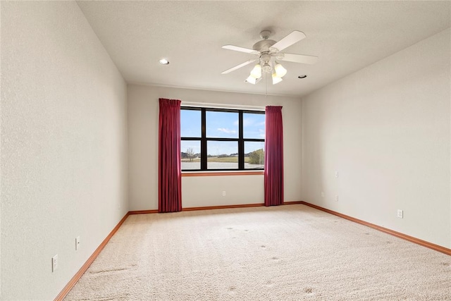 spare room with ceiling fan and carpet floors