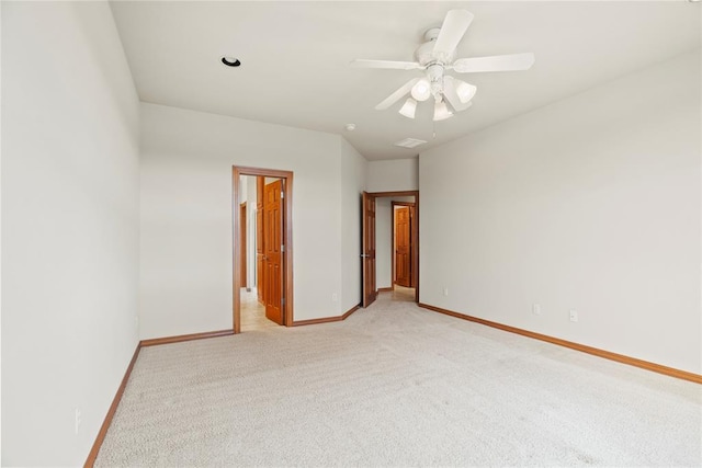 carpeted empty room featuring ceiling fan