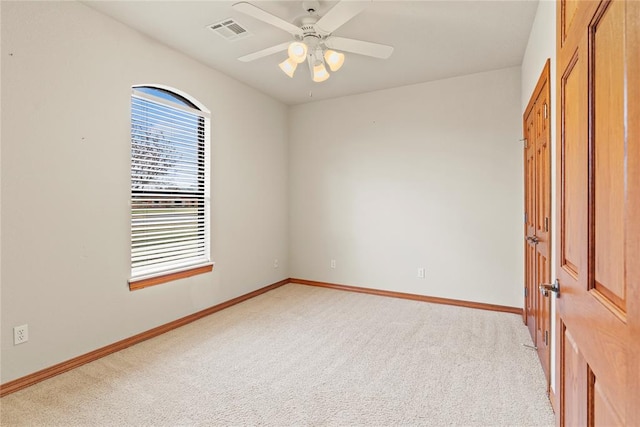 carpeted empty room featuring ceiling fan