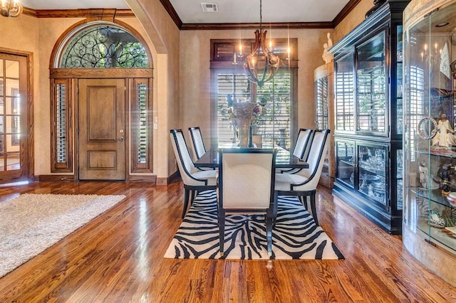 dining area with a notable chandelier, dark hardwood / wood-style floors, and plenty of natural light