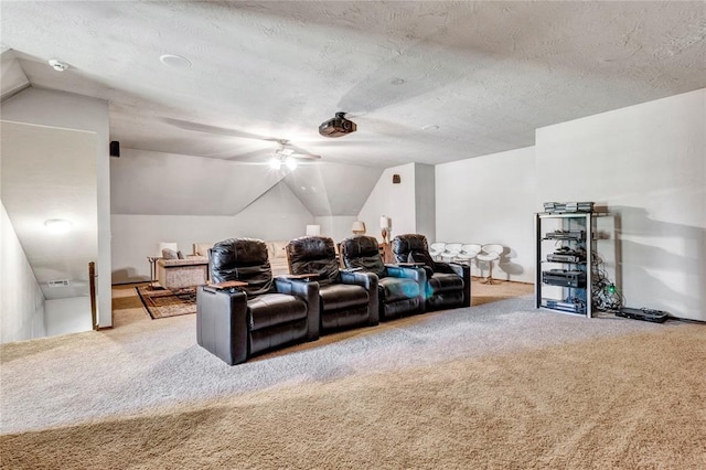 carpeted home theater room featuring lofted ceiling and a textured ceiling