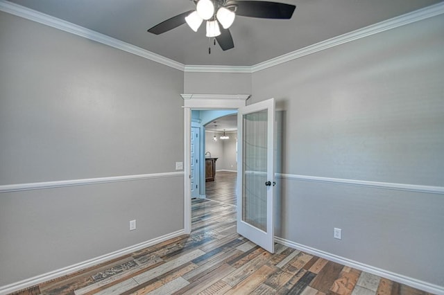 unfurnished room featuring ceiling fan, wood-type flooring, ornamental molding, and french doors