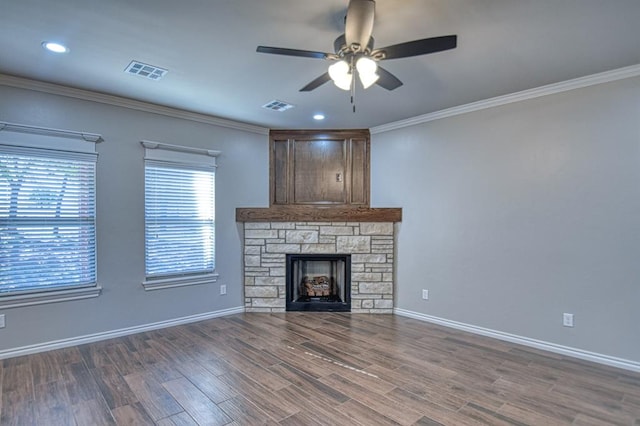 unfurnished living room with ceiling fan, dark hardwood / wood-style flooring, ornamental molding, and a fireplace