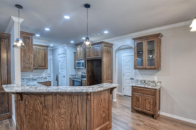 kitchen featuring kitchen peninsula, decorative light fixtures, stainless steel appliances, and dark hardwood / wood-style floors