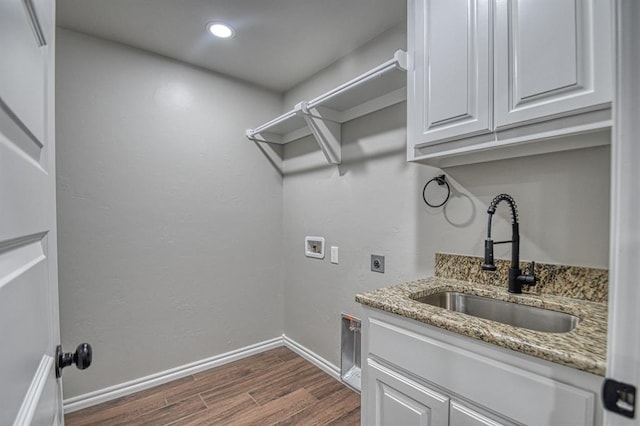 laundry area featuring cabinets, sink, hookup for a washing machine, dark hardwood / wood-style floors, and hookup for an electric dryer