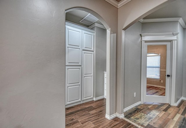 entryway featuring crown molding and dark hardwood / wood-style floors