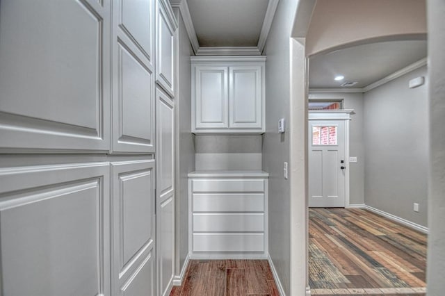 interior space featuring dark hardwood / wood-style floors and ornamental molding