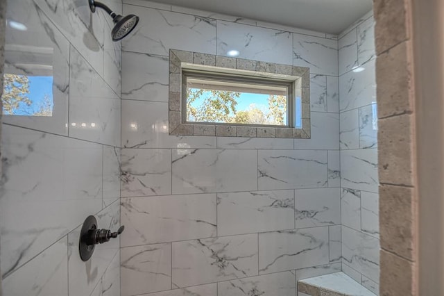 bathroom with a tile shower