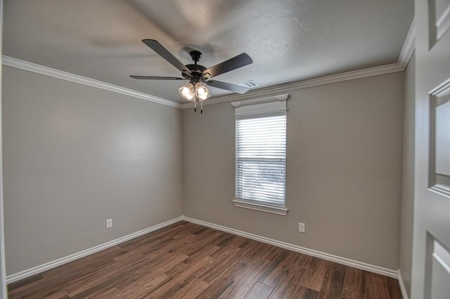 spare room featuring dark hardwood / wood-style flooring, ceiling fan, and ornamental molding