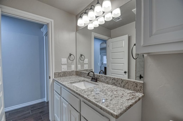 bathroom with hardwood / wood-style flooring and vanity