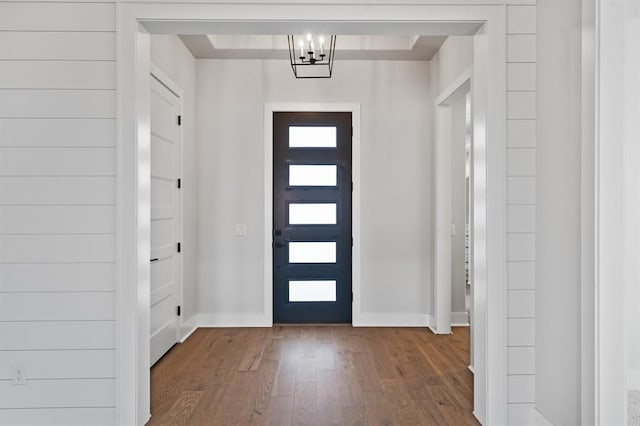 entrance foyer with hardwood / wood-style floors and a chandelier