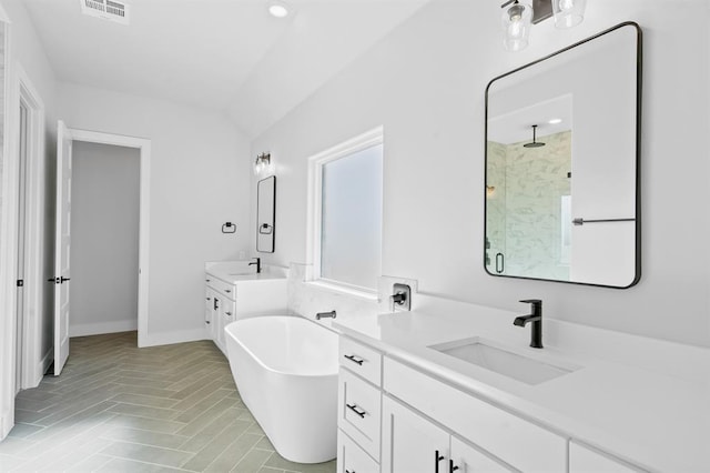 bathroom featuring vanity, lofted ceiling, and independent shower and bath