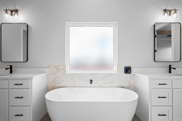 bathroom with a bathtub, vanity, and tile walls