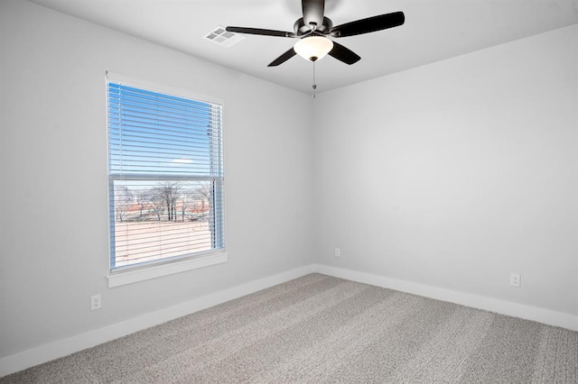 spare room with carpet, ceiling fan, and a healthy amount of sunlight