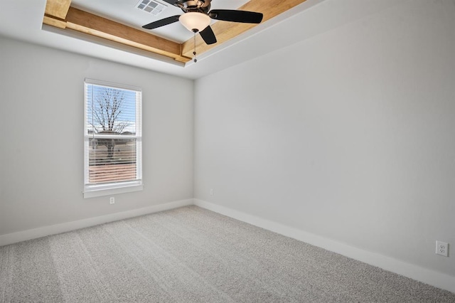 unfurnished room featuring a raised ceiling, ceiling fan, and carpet flooring