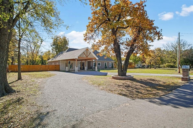 ranch-style home with covered porch and a front lawn