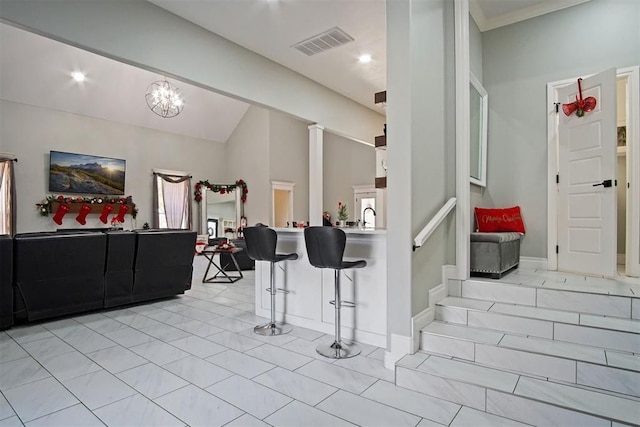 interior space featuring lofted ceiling, sink, and an inviting chandelier