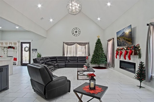 tiled living room with a notable chandelier and high vaulted ceiling