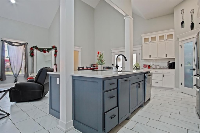 kitchen with gray cabinets, light tile patterned flooring, white cabinetry, and high vaulted ceiling