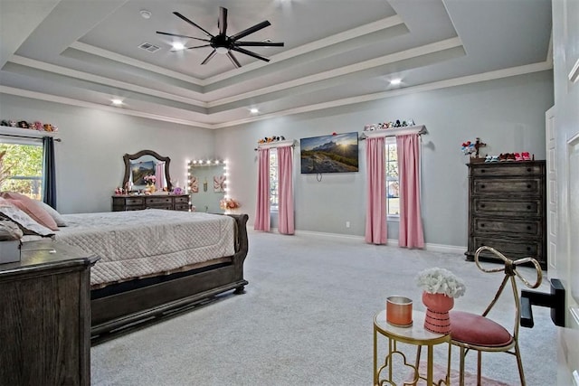 bedroom featuring a raised ceiling, light colored carpet, and ornamental molding