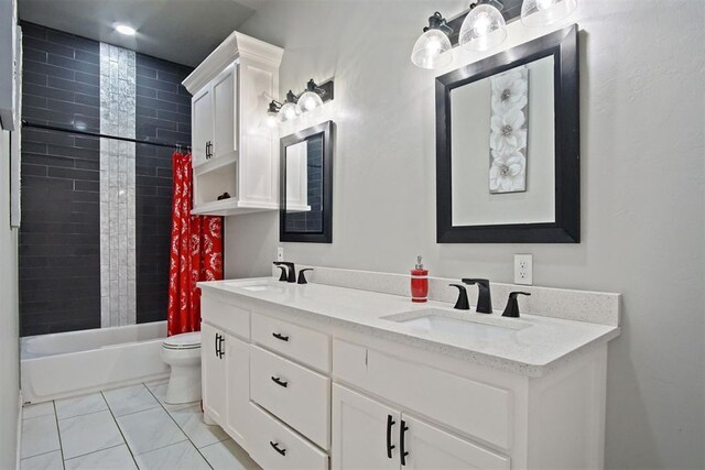 full bathroom with tile patterned floors, vanity, toilet, and shower / bath combo with shower curtain