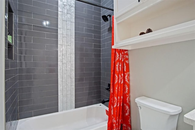 bathroom featuring shower / tub combo and toilet