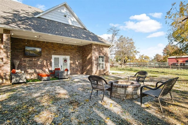 view of patio with french doors and an outdoor fire pit