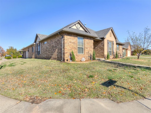 single story home featuring a garage and a front lawn