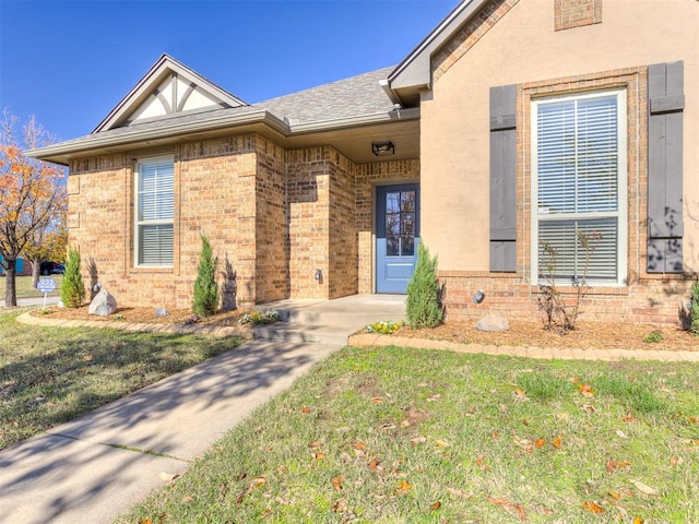 doorway to property featuring a yard