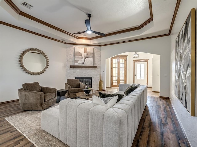 living room with ceiling fan, dark hardwood / wood-style flooring, and ornamental molding