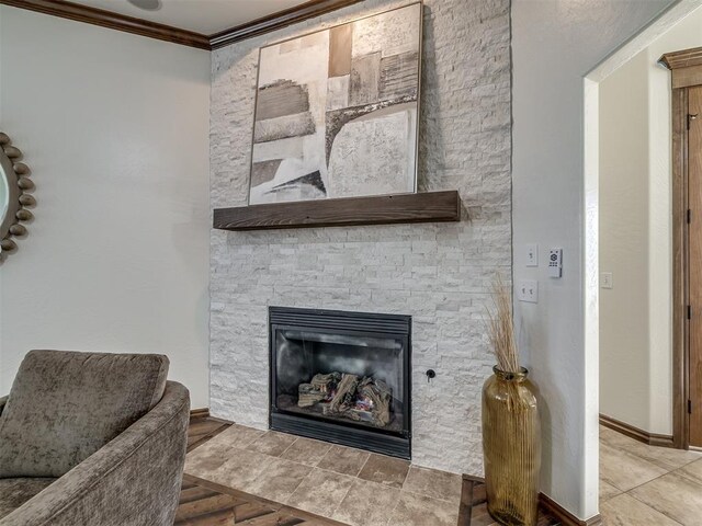 room details with a stone fireplace, wood-type flooring, and ornamental molding