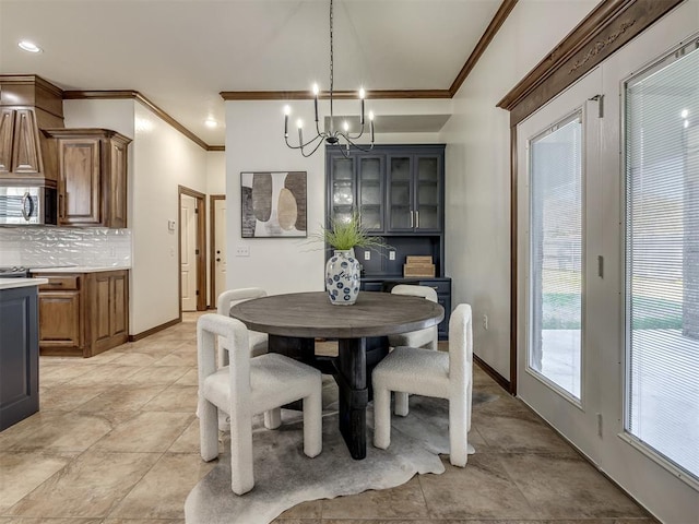 dining room with a notable chandelier and ornamental molding