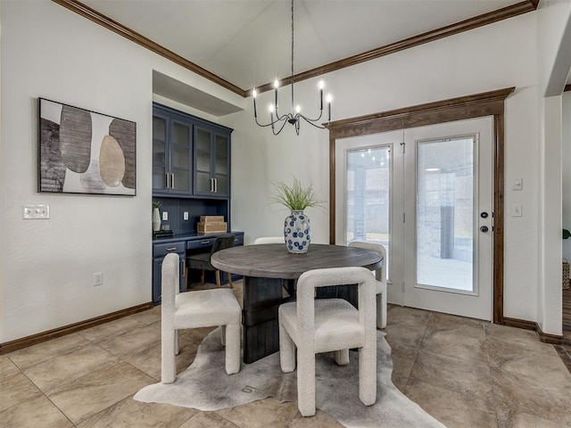 dining room with crown molding and a chandelier