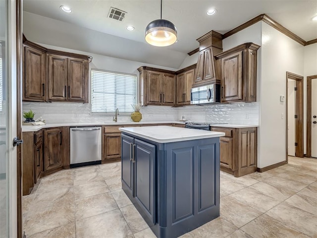 kitchen with a center island, tasteful backsplash, pendant lighting, appliances with stainless steel finishes, and ornamental molding