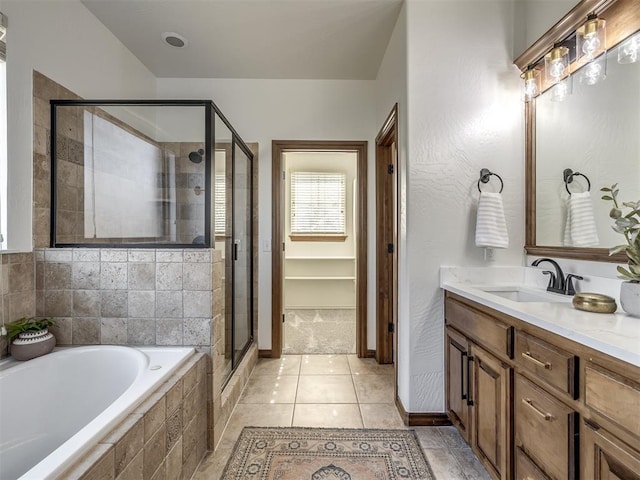 bathroom featuring tile patterned floors, vanity, and shower with separate bathtub