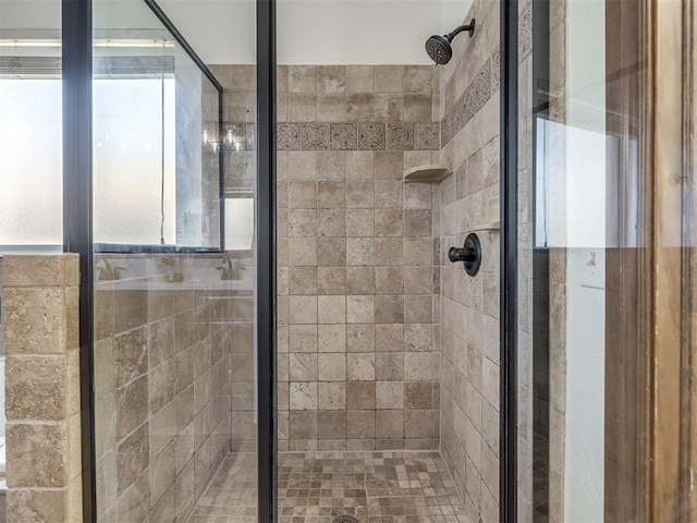 bathroom with a shower with door