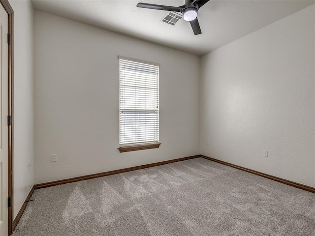 carpeted empty room featuring ceiling fan