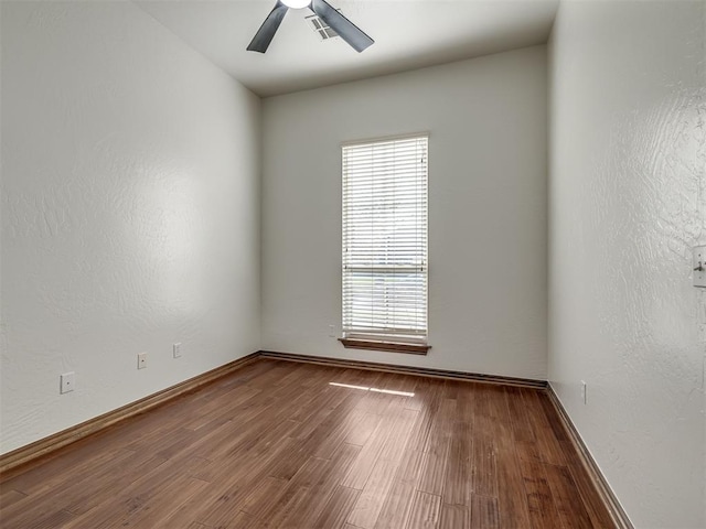 unfurnished room with ceiling fan and wood-type flooring