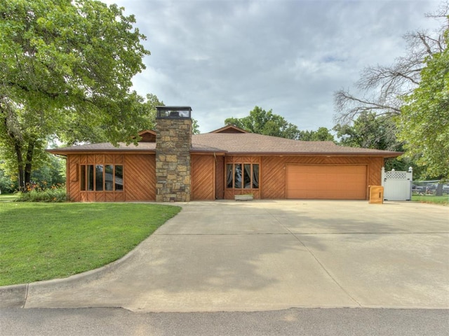 1501 S Avery Ave, Midwest City, OK 73130 - mid-century inspired home featuring an attached garage, concrete driveway, and a chimney