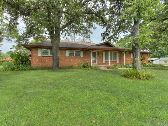 1501 S Avery Ave, Midwest City, OK 73130 - ranch-style home featuring a front lawn and brick siding