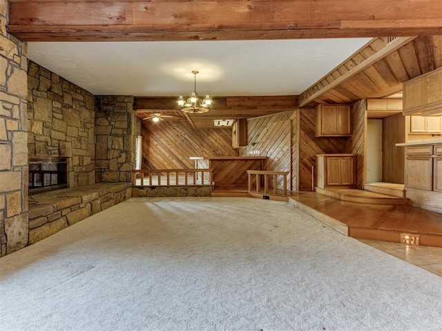 1501 S Avery Ave, Midwest City, OK 73130 - unfurnished living room with wood walls, beamed ceiling, a chandelier, a fireplace, and carpet