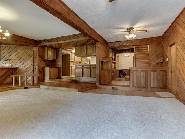 1501 S Avery Ave, Midwest City, OK 73130 - unfurnished living room featuring wooden walls, a chandelier, light colored carpet, and ceiling fan