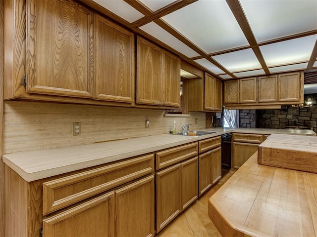 1501 S Avery Ave, Midwest City, OK 73130 - kitchen featuring brown cabinetry, light wood finished floors, tasteful backsplash, and black dishwasher