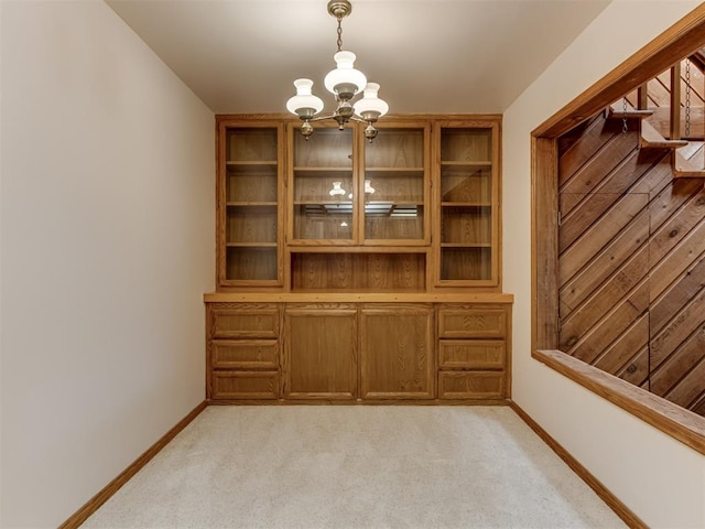 1501 S Avery Ave, Midwest City, OK 73130 - unfurnished dining area featuring a chandelier, light carpet, and stairs