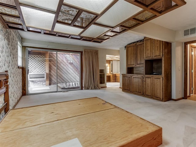 1501 S Avery Ave, Midwest City, OK 73130 - unfurnished living room featuring wallpapered walls and light carpet
