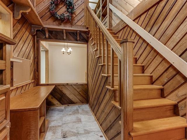 1501 S Avery Ave, Midwest City, OK 73130 - stairway with wooden walls, stone finish floors, and a chandelier